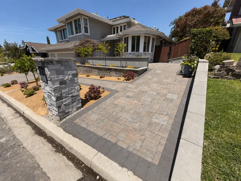 Interlocking paver driveway and walkway in front of a house